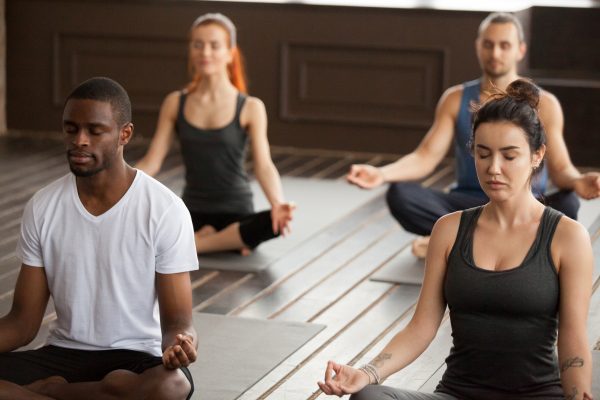 group-young-sporty-people-meditating-easy-seat-pose